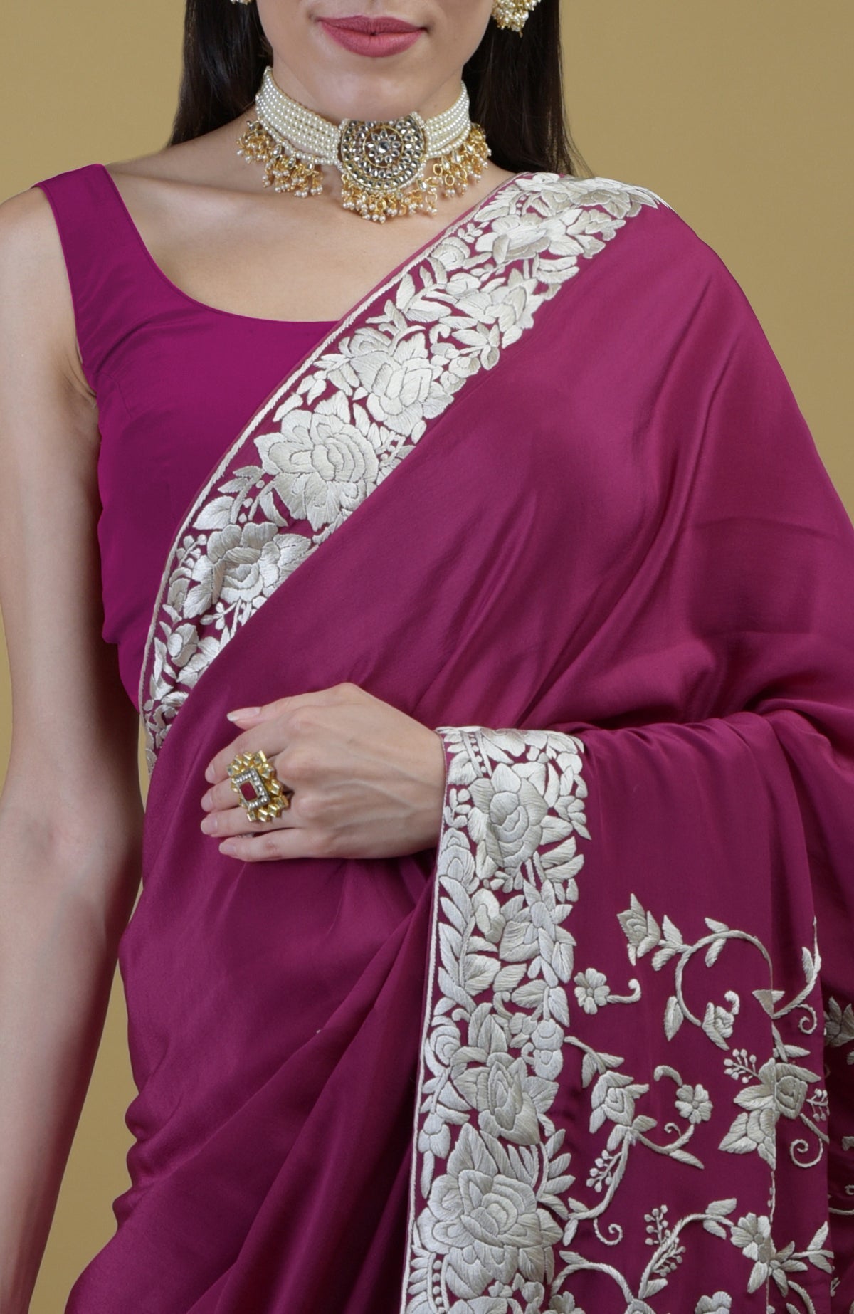 Peacock pink Parsi Gara hand embroidered saree with intricate ivory floral patterns.