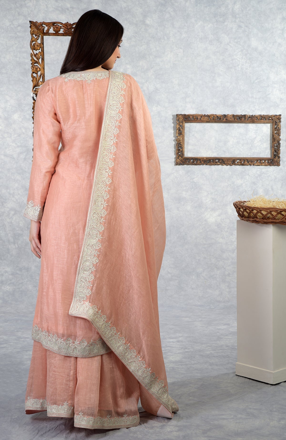 Pale peach Kashmiri Tilla embroidered kurta set with a dupatta and sharara.