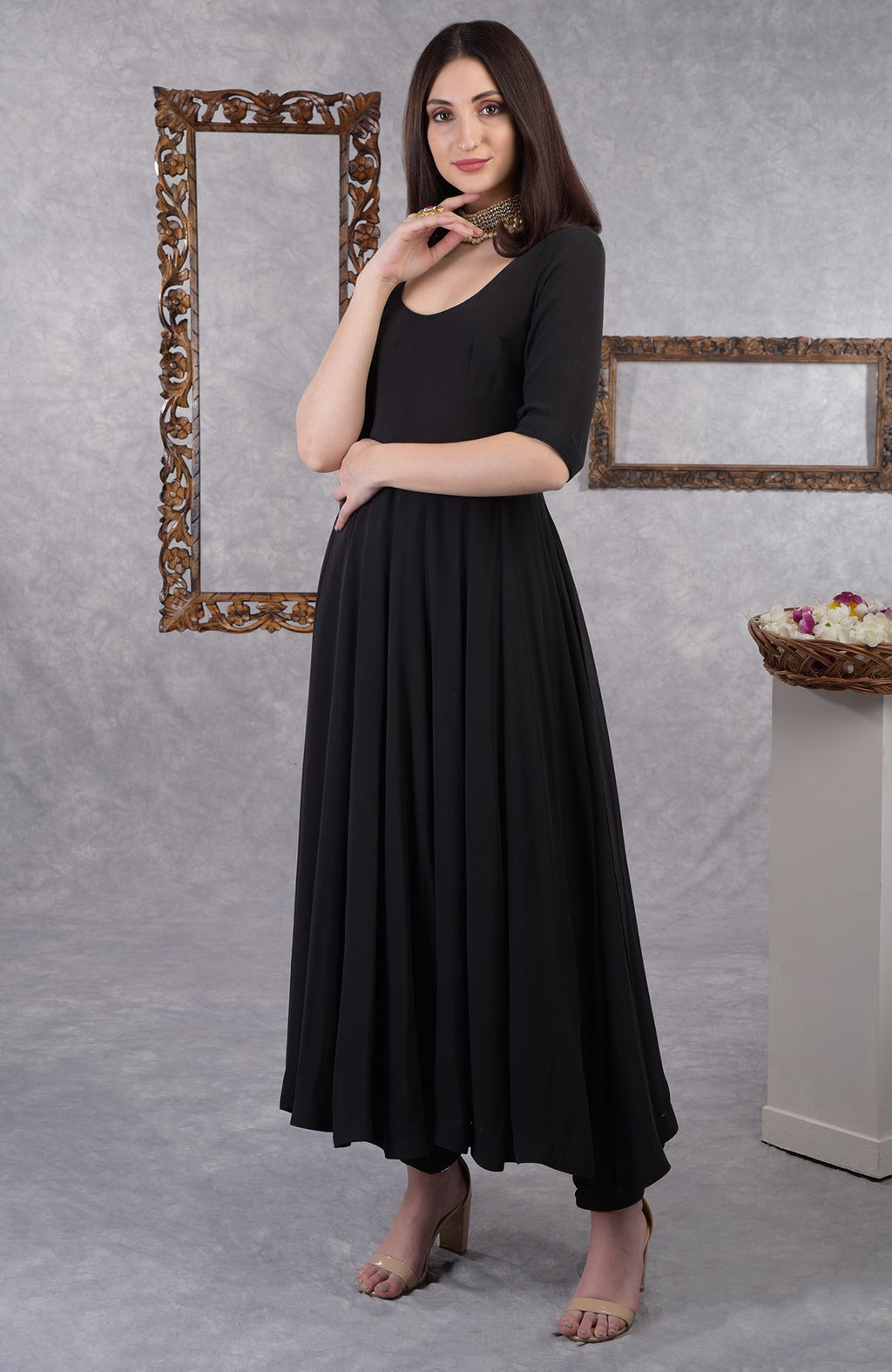 A woman models a black pure georgette Anarkali set with churidar pants.