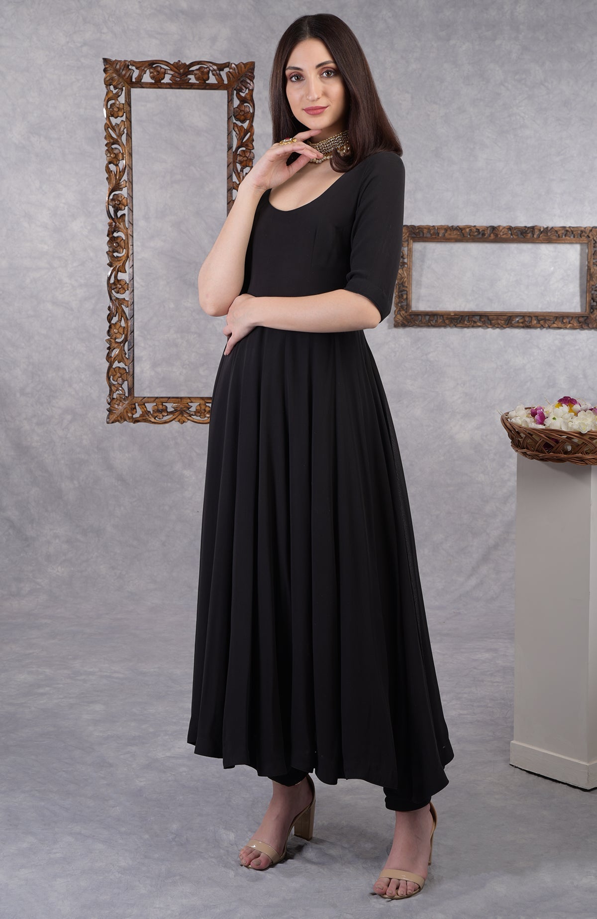 A woman models a black pure georgette Anarkali set with churidar pants.