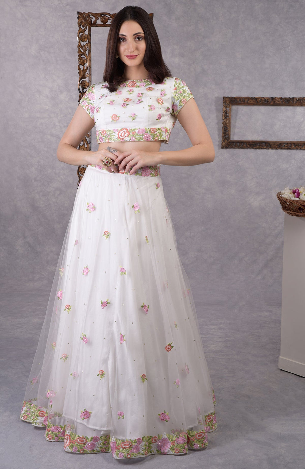 Pearl white lehenga set with pastel floral resham embroidery and sequin on blouse, skirt, and dupatta.