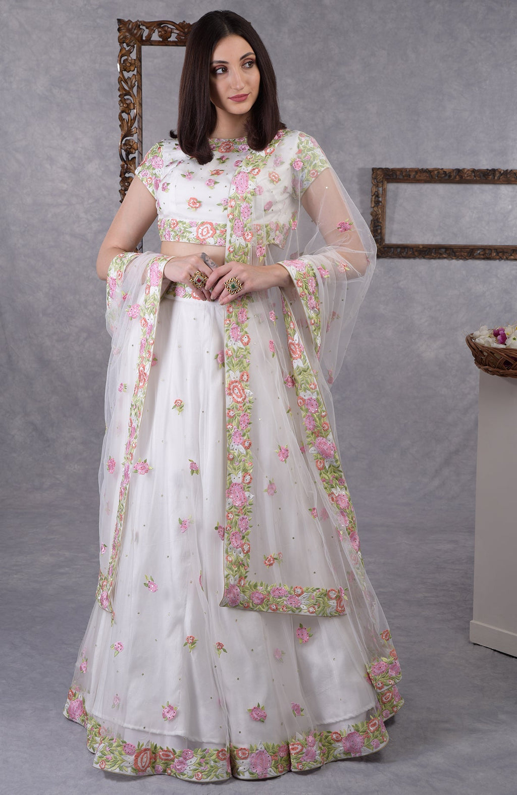 Pearl white lehenga set with multicolor resham floral embroidery and sequin details on blouse, skirt, and dupatta