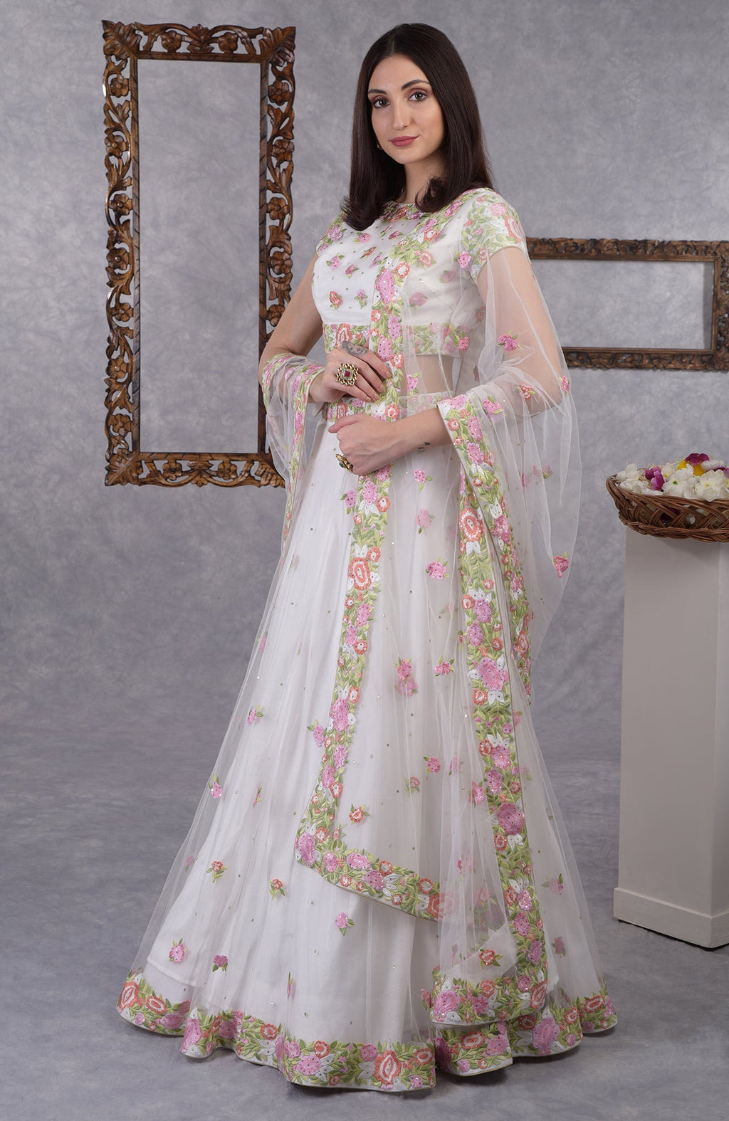 Pearl white lehenga set with pastel resham floral embroidery and sequin on blouse, skirt, and dupatta.