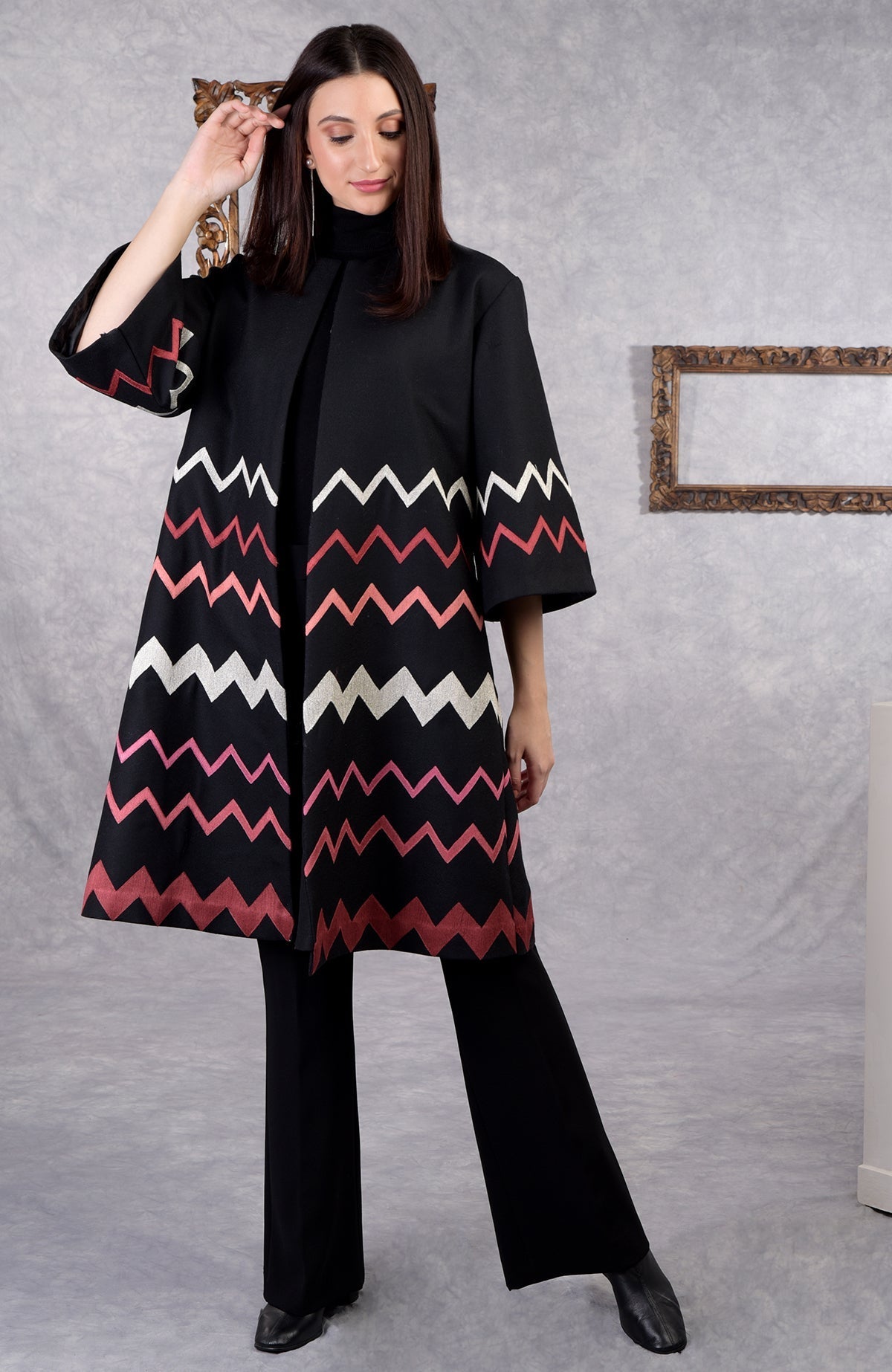 Black wool crepe kimono jacket with chevron embroidery in copper, pink, peach, and silver tones.