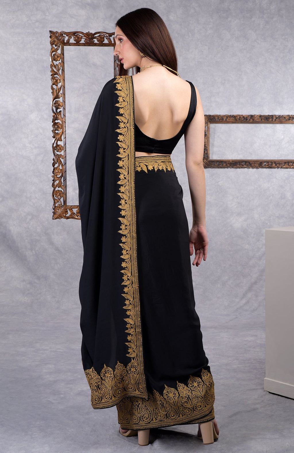 Black crepe saree with gold Kashmiri tilla aari floral and paisley embroidery on border