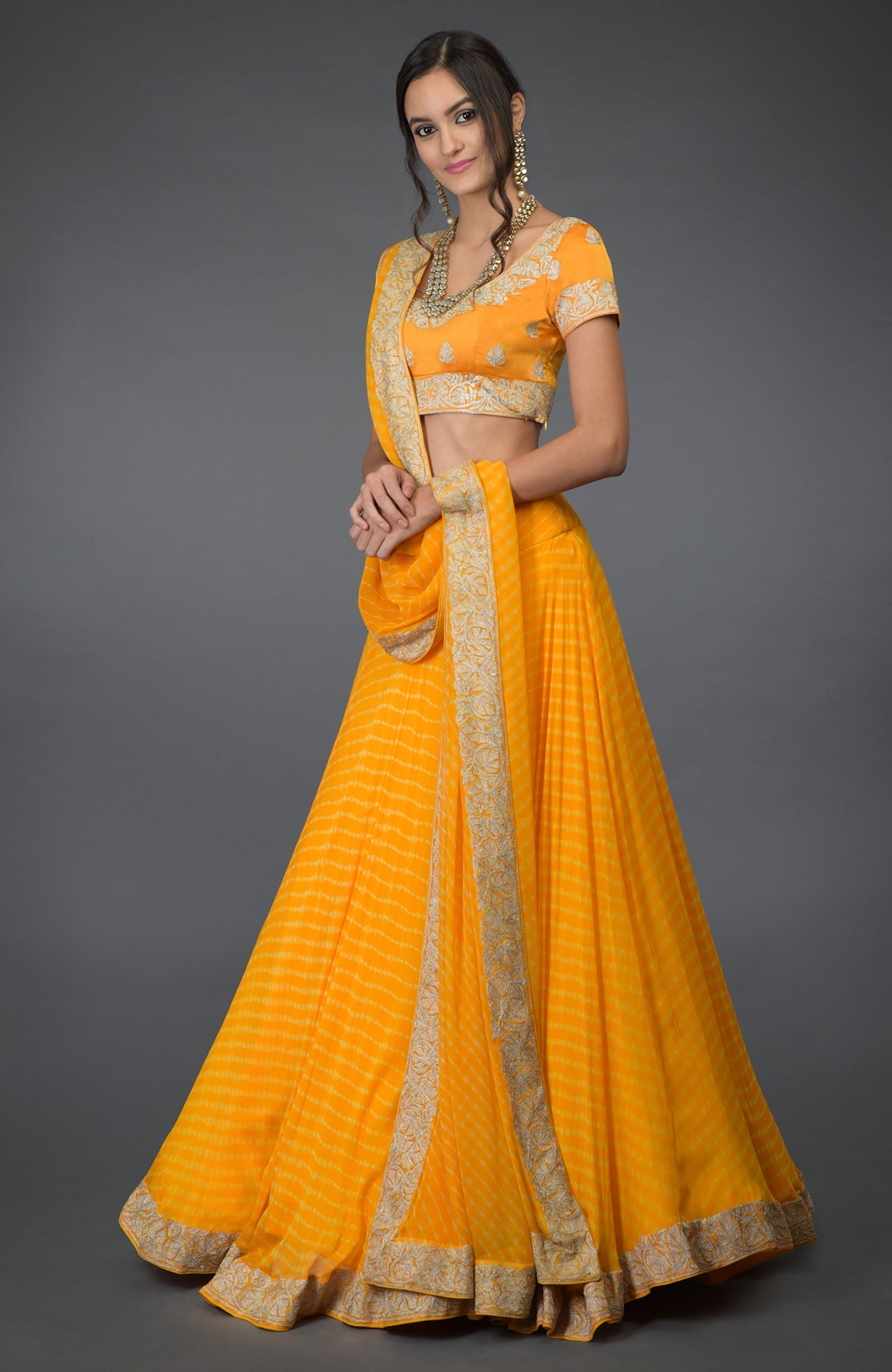 Yellow chiffon lehenga set with silver tilla embroidery and satin silk blouse with cap sleeves