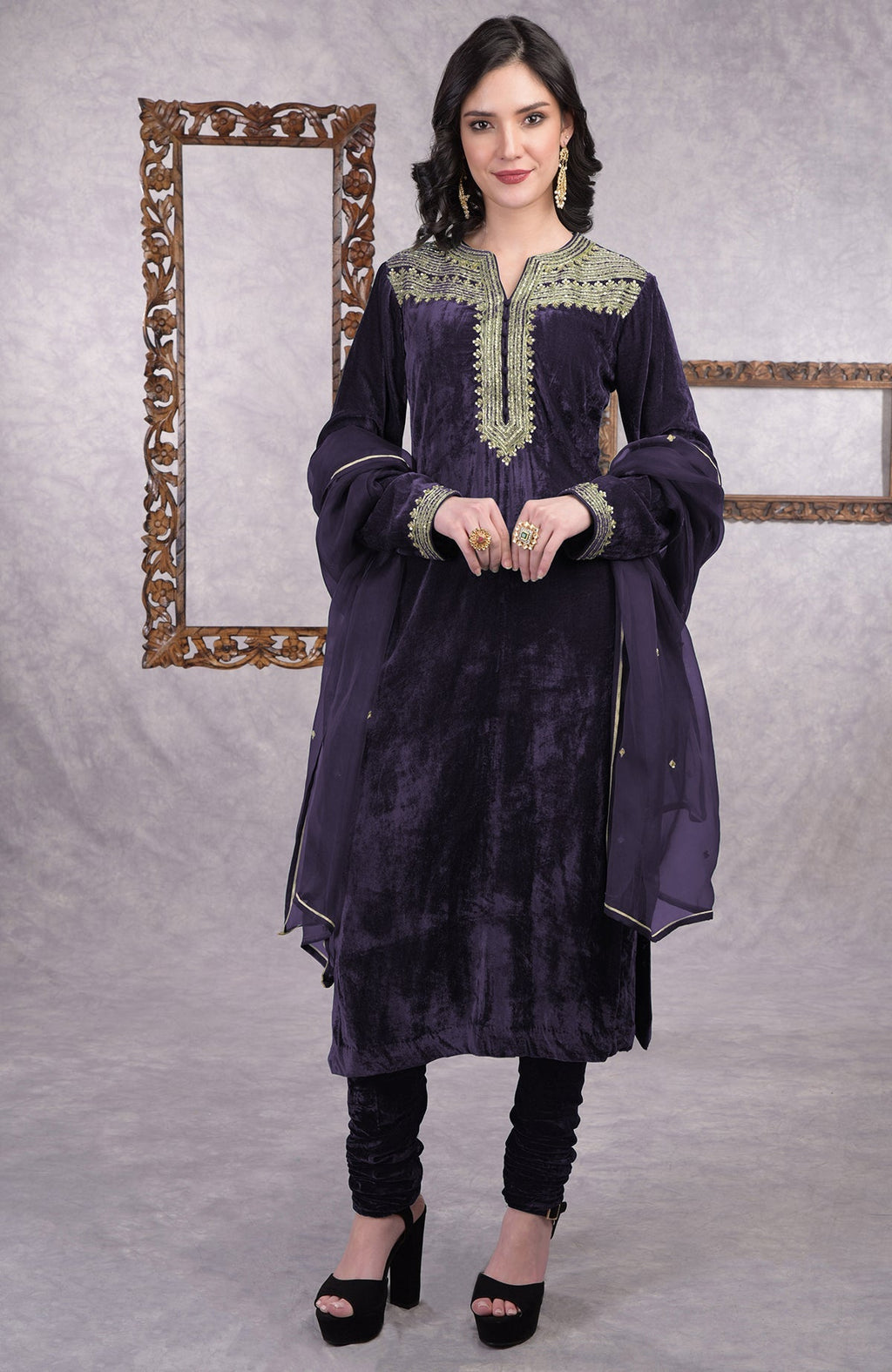 Rich green velvet kurta set with gold zardozi embroidery and matching churidar and dupatta.