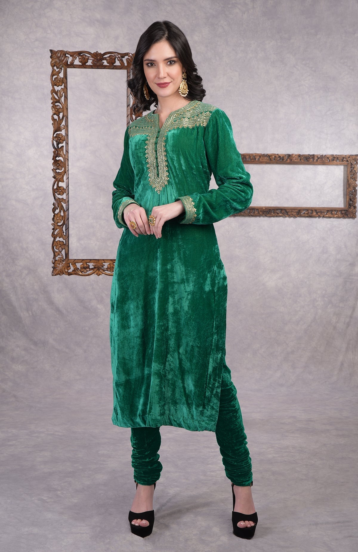 Rich green velvet kurta set with gold zardozi embroidery and matching churidar and dupatta.