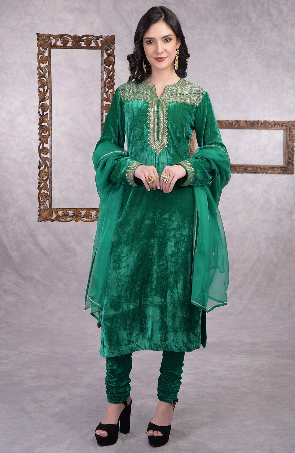 Rich green velvet kurta set with gold zardozi embroidery and matching churidar and dupatta.