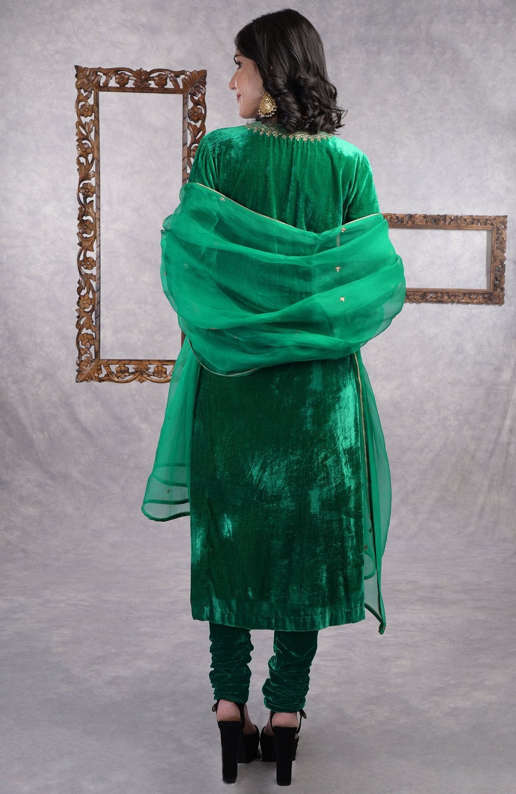 Rich green velvet kurta set with gold zardozi embroidery and matching churidar and dupatta.