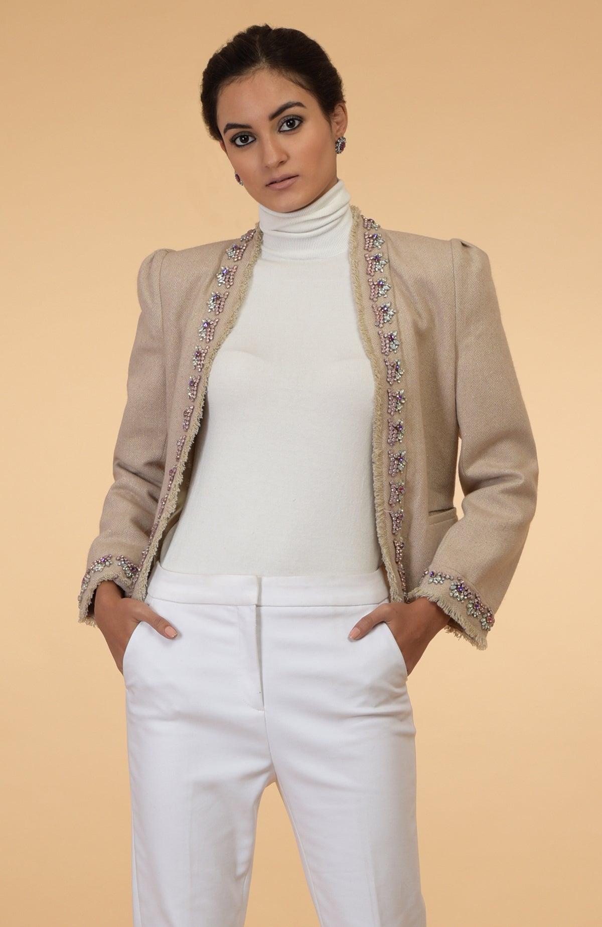 Beige cropped tweed jacket with long sleeves and purple, pink, silver crystal embroidery.