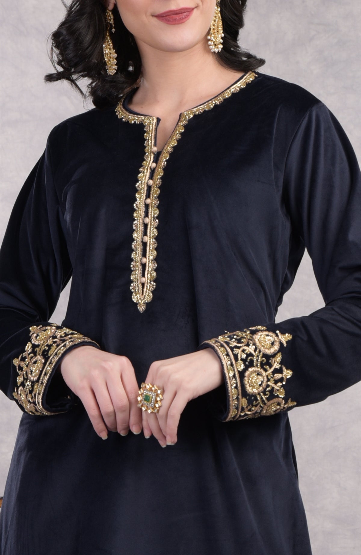 Midnight blue velvet sharara set with gold zardozi embroidery and floral organza dupatta.
