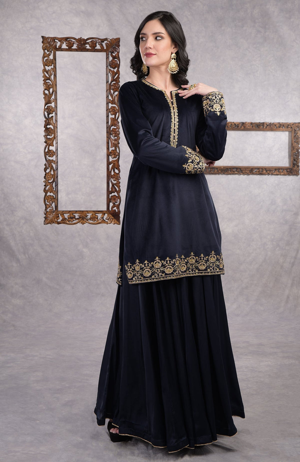 Midnight blue velvet sharara set with gold zardozi embroidery and floral organza dupatta.