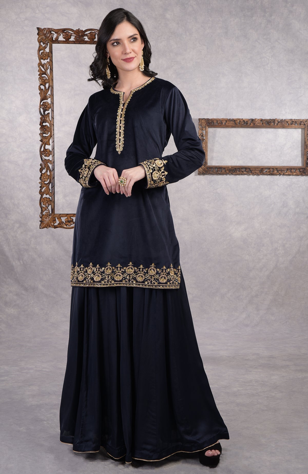 Midnight blue velvet sharara set with gold zardozi embroidery and floral organza dupatta.