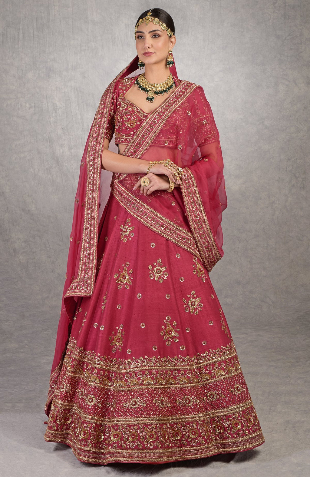 Red raw silk lehenga set with gold zardozi floral embroidery and matching silk organza veil.