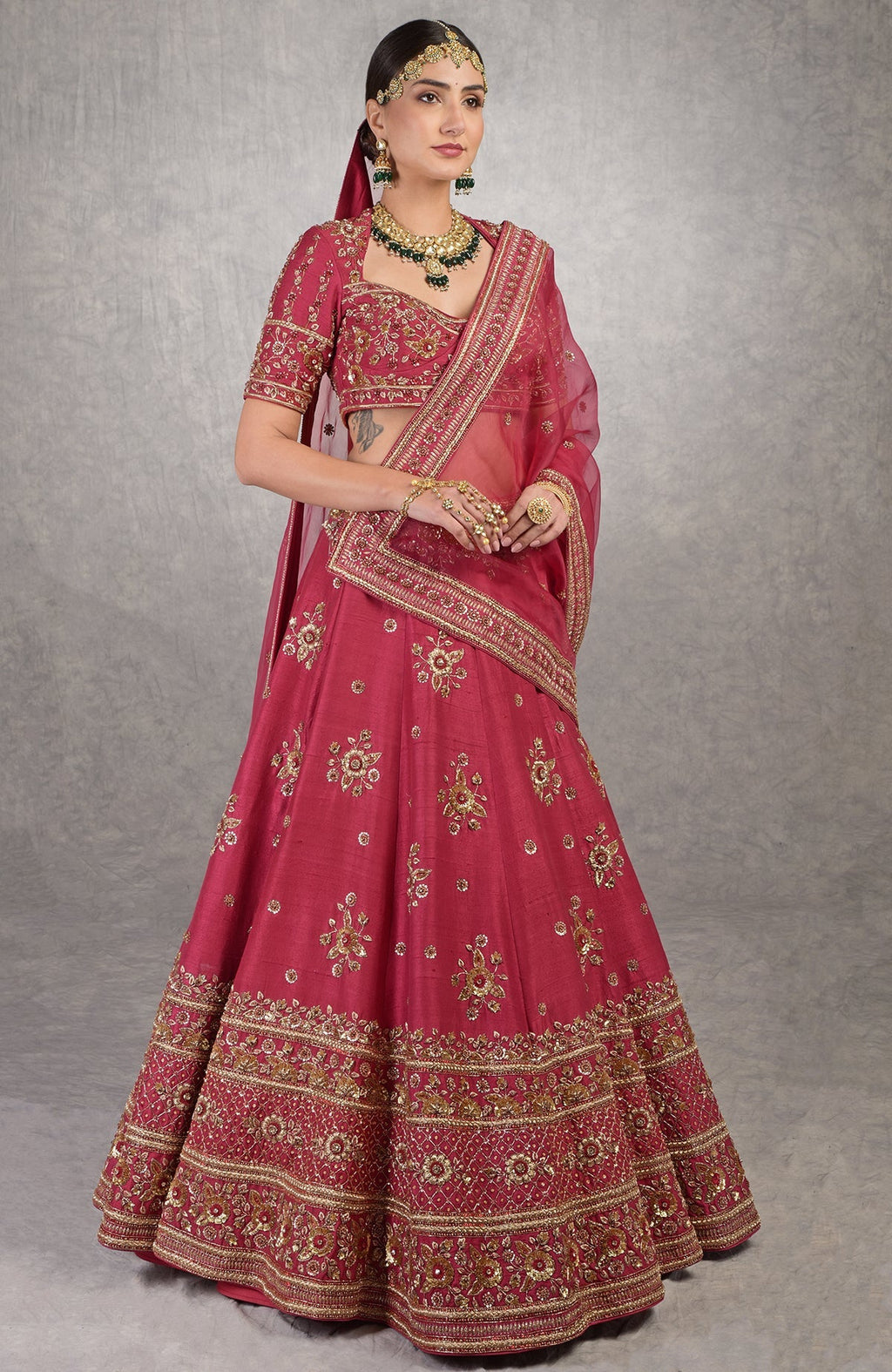Deep red lehenga set with gold zardozi floral embroidery on raw silk and silk organza dupatta.