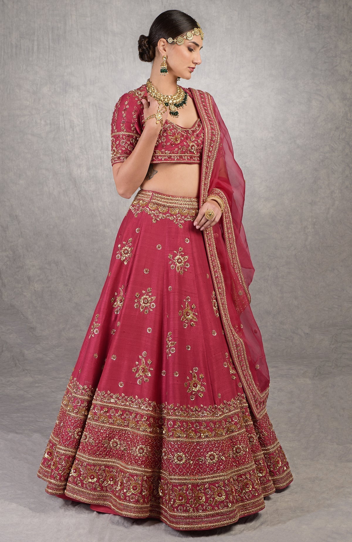 Red raw silk lehenga set with gold zardozi floral embroidery and matching silk organza veil.