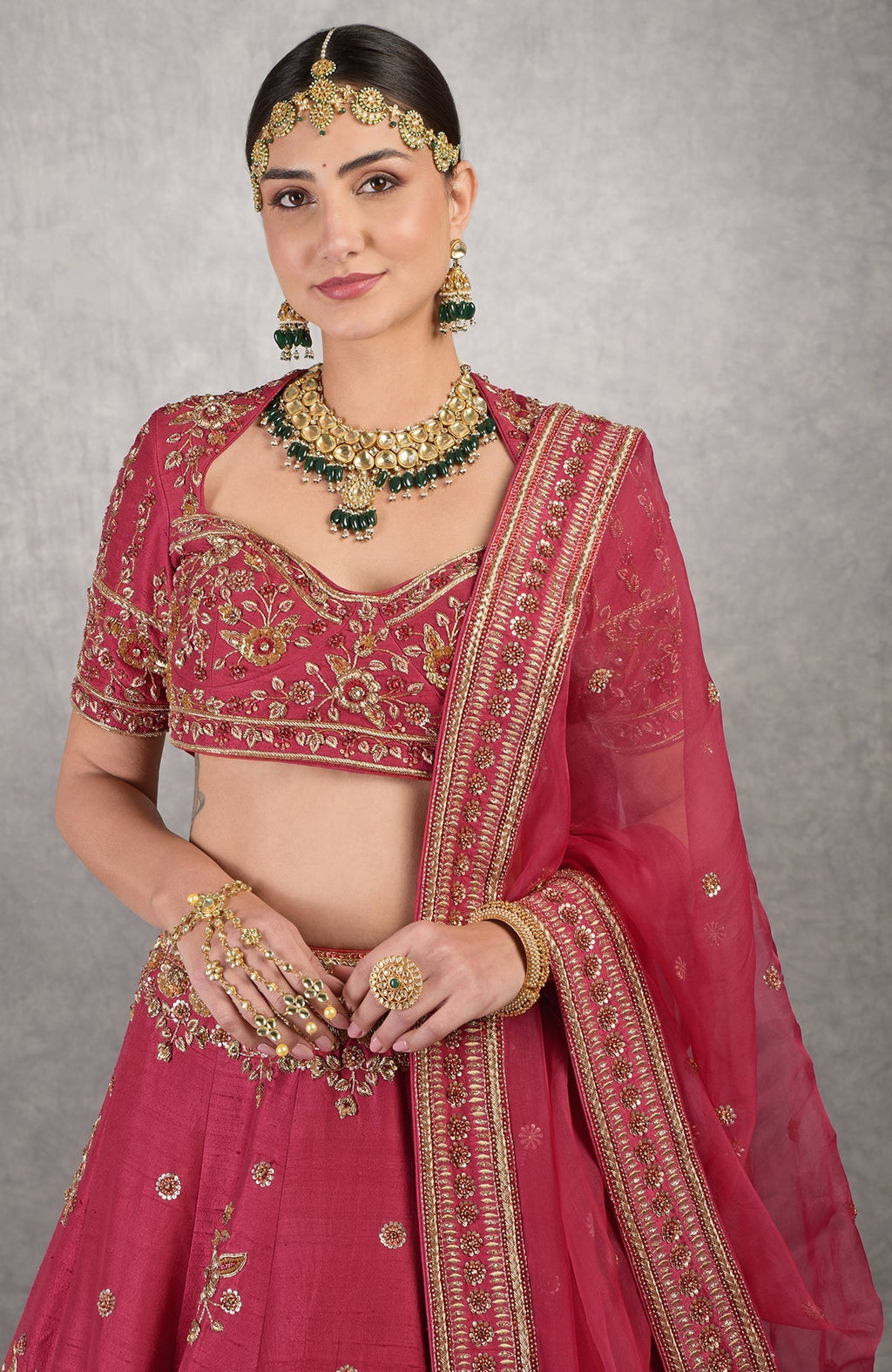 Red raw silk lehenga set with gold zardozi floral embroidery and matching silk organza veil.