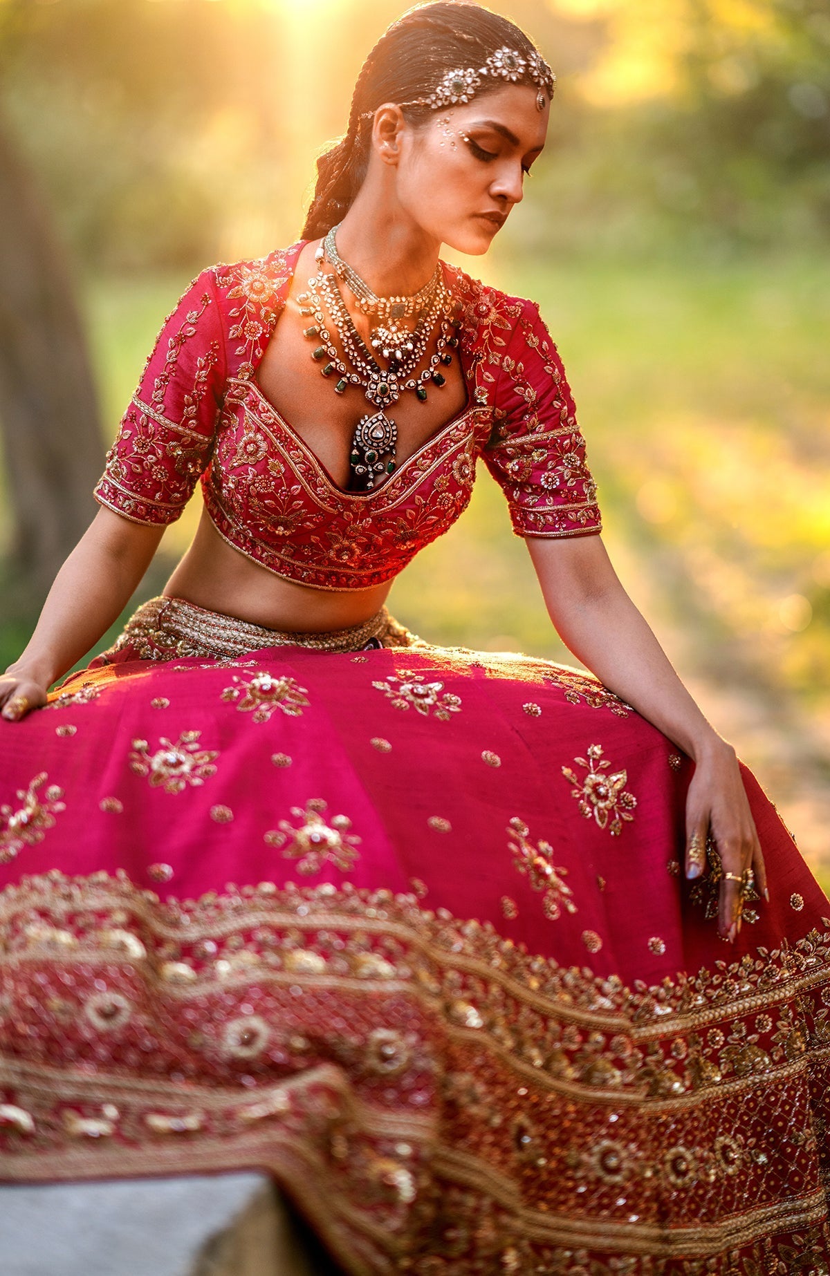 Red raw silk lehenga set with gold floral zardozi embroidery and matching embroidered blouse and dupatta.