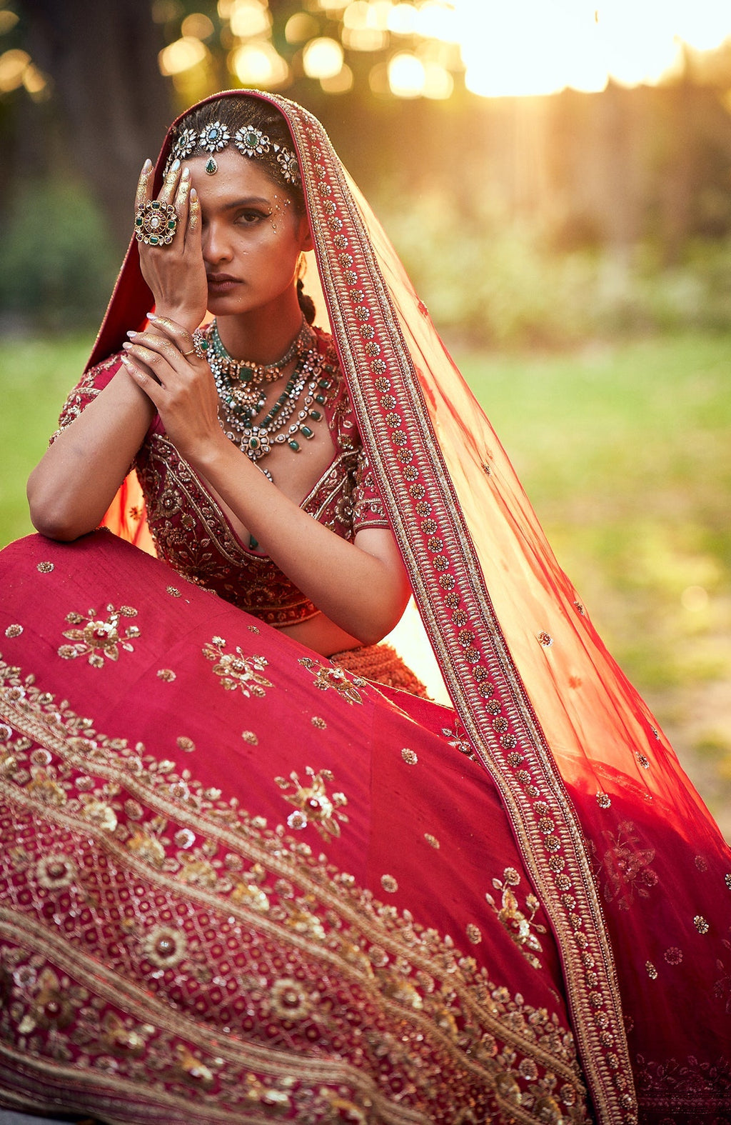 Deep red raw silk lehenga set with gold zardozi floral embroidery and silk organza dupatta.