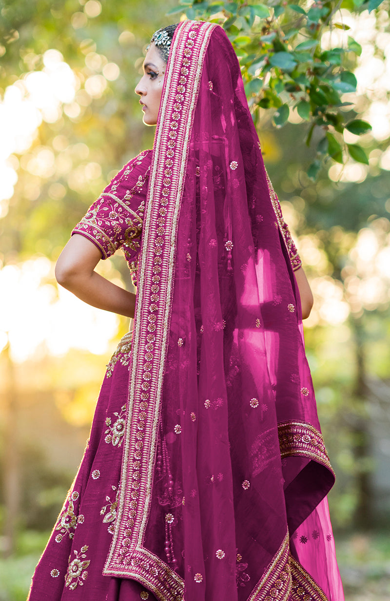 Purple wine lehenga set with gold zardozi embroidery and a sheer dupatta.