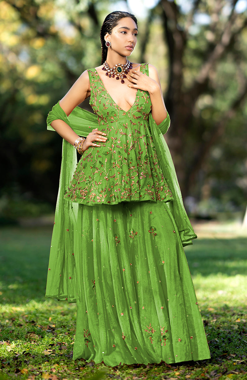 A woman models a Mehandi green 3D floral and zardozi hand-embroidered sharara set.