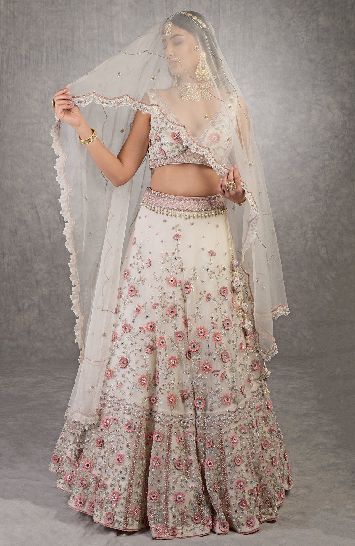 Off-white lehenga set with 3-D pink floral embroidery, crystal beadwork, and silk organza fabric.