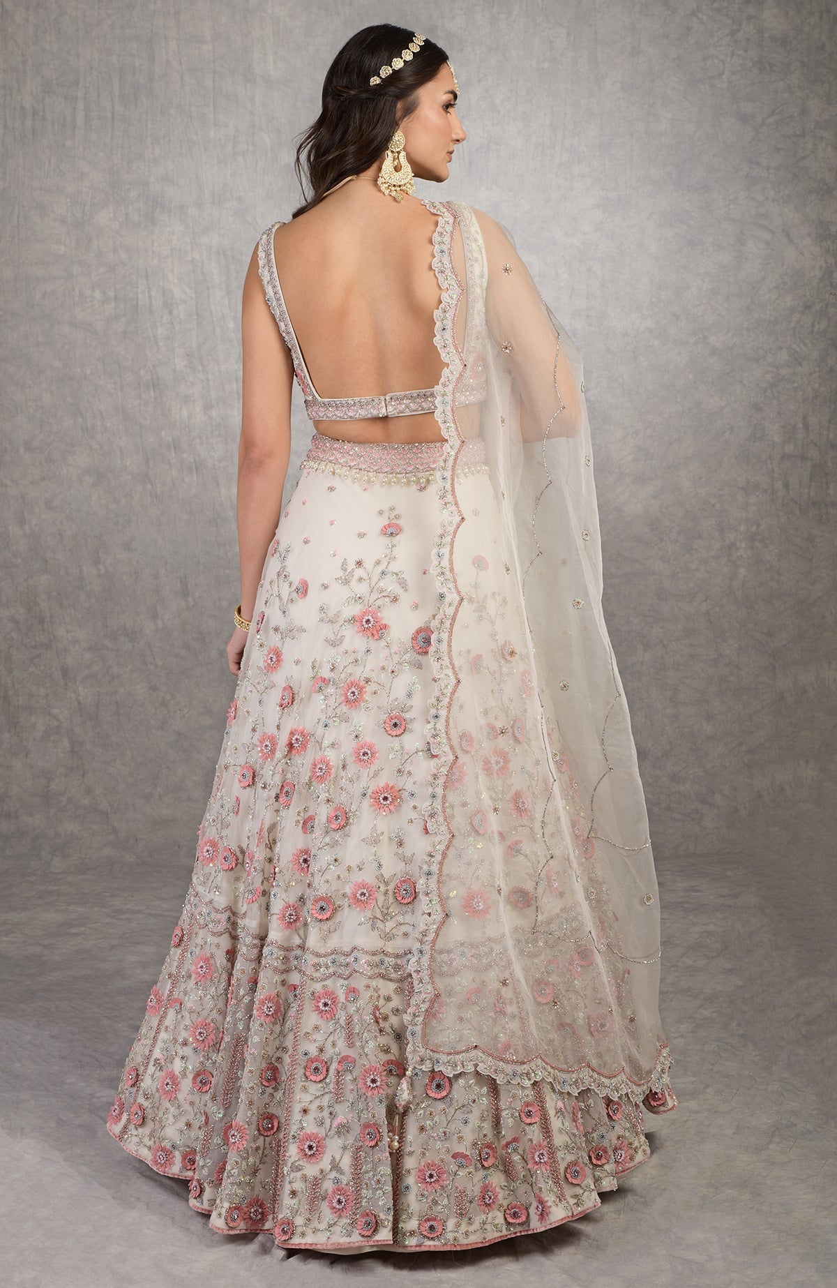 Off-white lehenga set with 3-D pink floral embroidery, crystal beads, and deep V-neck blouse