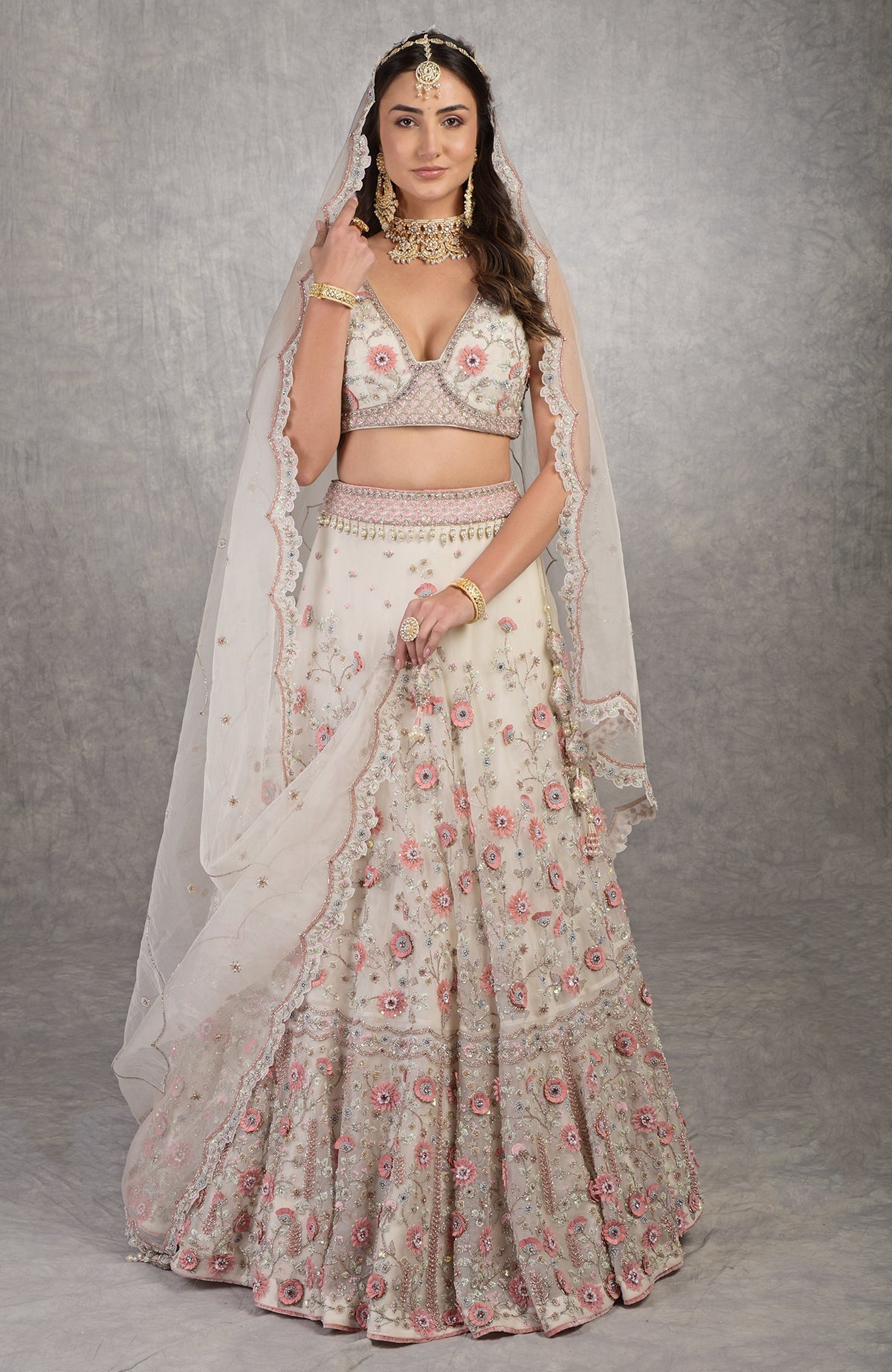 Off-white lehenga set with 3-D pink floral embroidery and crystal-bead embellishments on silk organza.