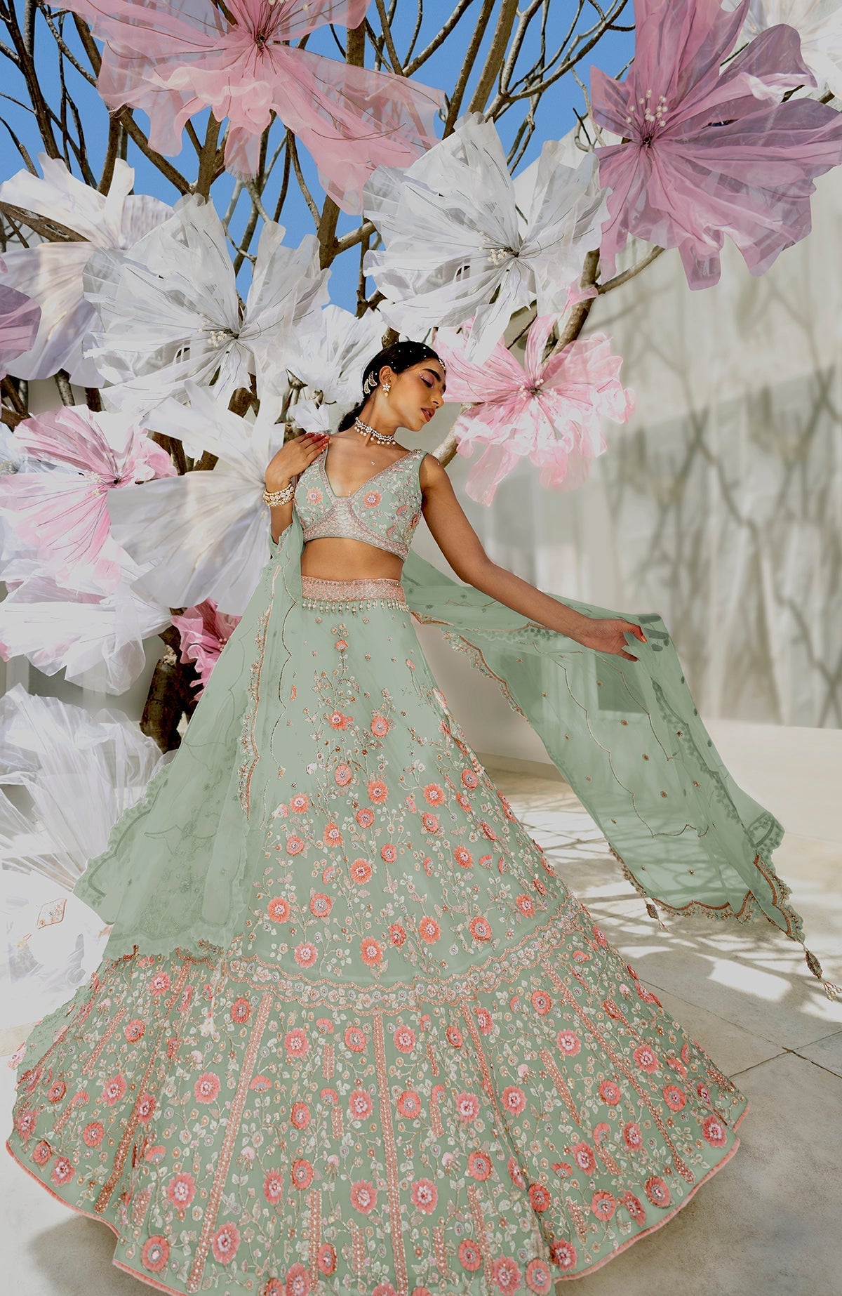 Off-white lehenga set with 3-D pink floral embroidery, crystal beadwork, and silk organza fabric.