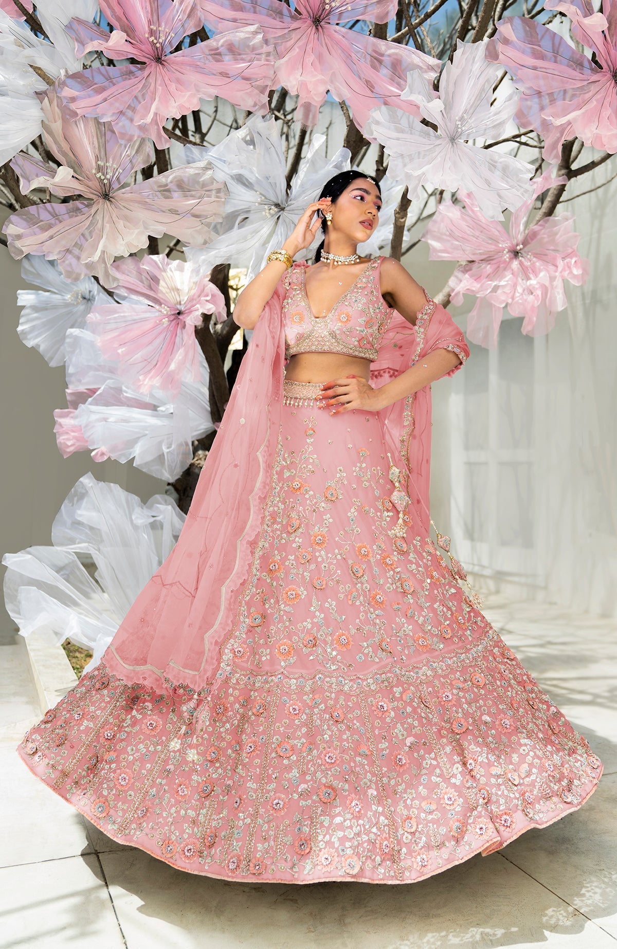 Off-white lehenga set with 3-D pink floral embroidery and crystal bead detailing on silk organza.