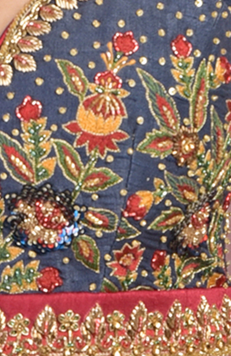 Classic blue raw silk blouse with gold zardozi and multicolor floral embroidery and cap sleeves.