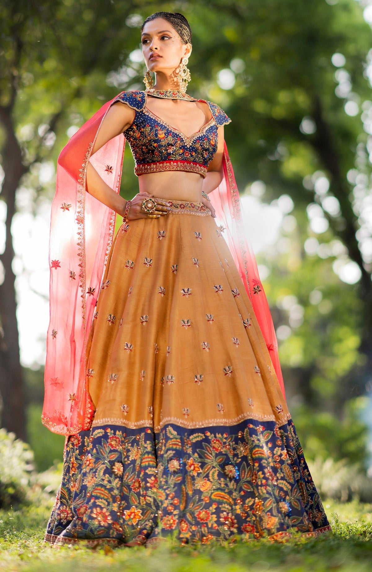 Classic blue lehenga with intricate floral embroidery, gold zardozi, and mustard accents.