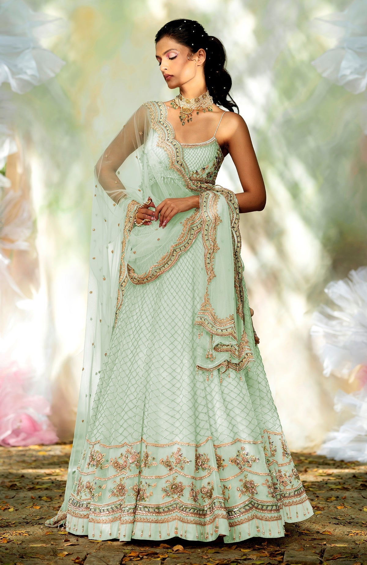 Champagne pink lehenga set with floral bead embroidery, scoop neck blouse, and scalloped tulle veil.