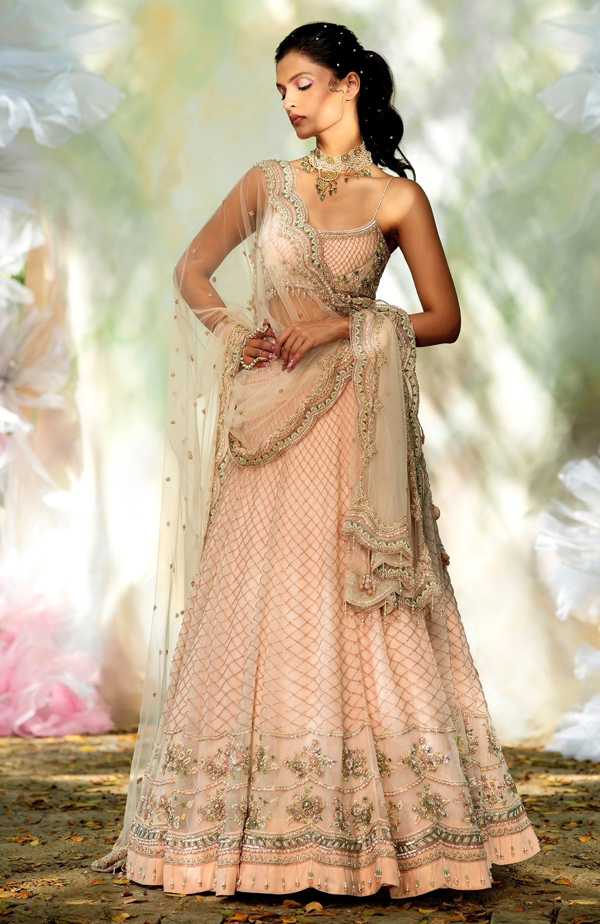 Champagne pink lehenga set with floral bead embroidery, scoop neck blouse, and scalloped tulle veil.