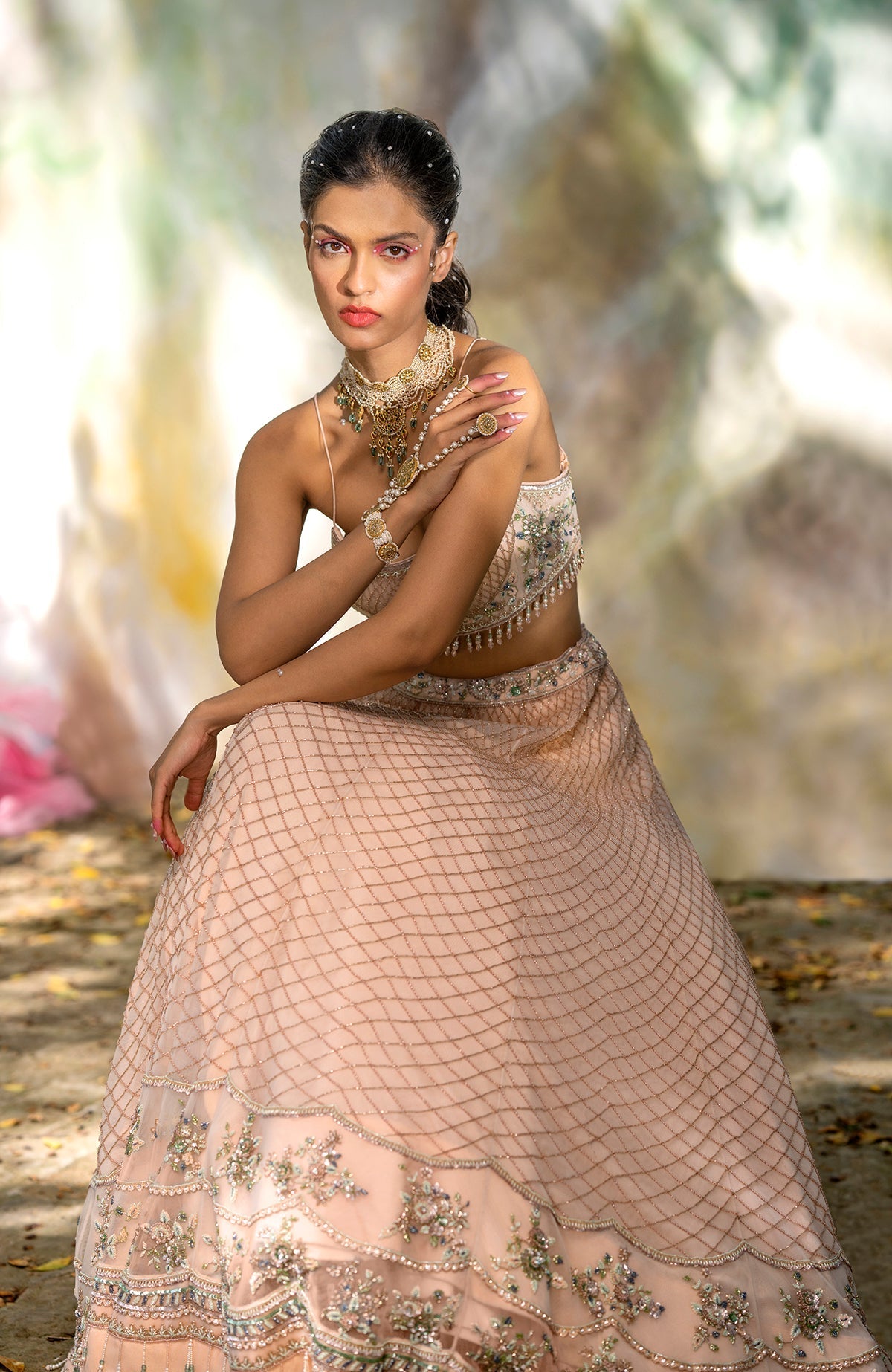 Champagne pink lehenga set with floral bead embroidery, scalloped tulle veil, and scoop neck blouse.