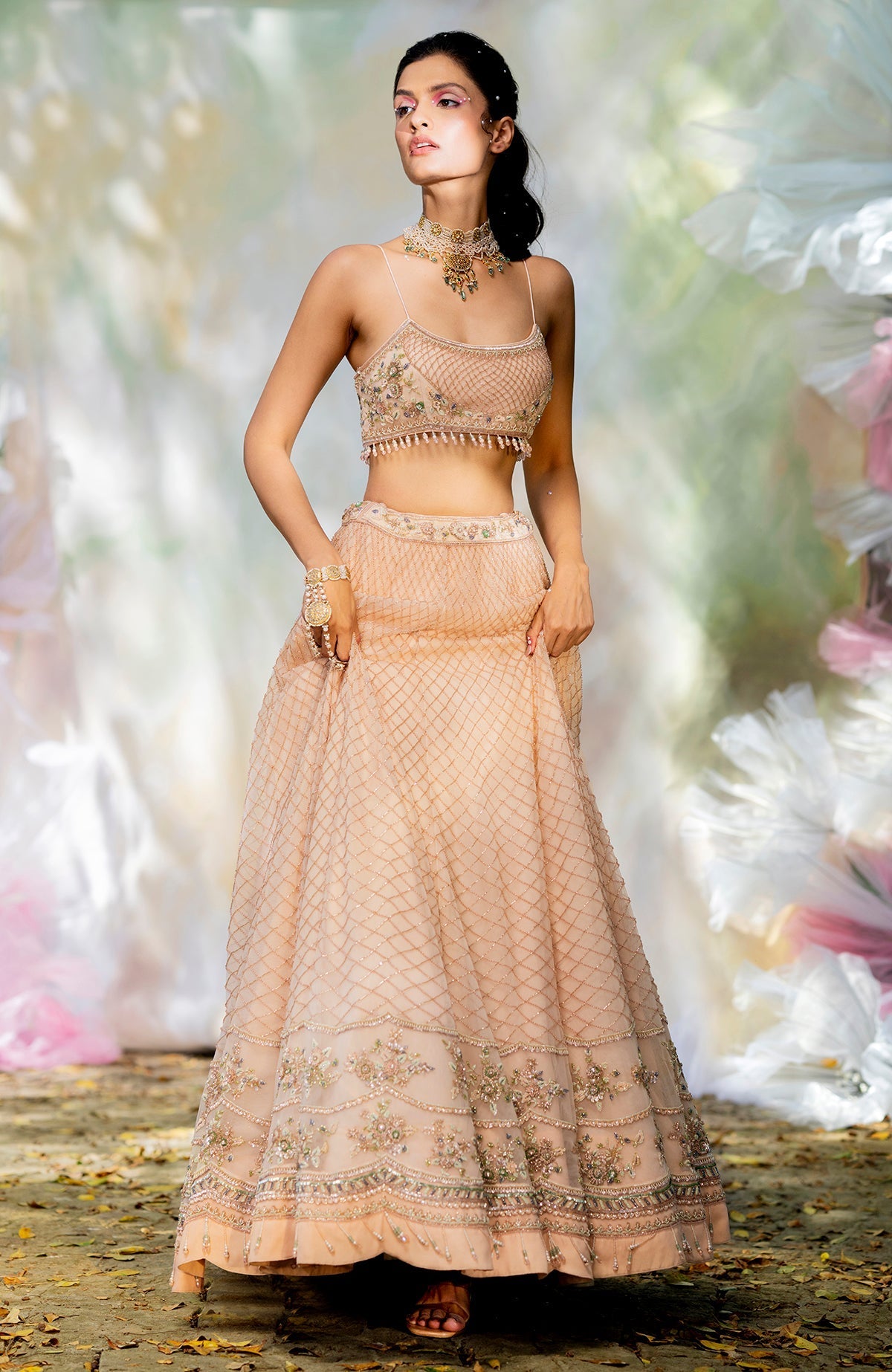 Champagne pink lehenga set with floral bead embroidery, scoop neck blouse, and scalloped tulle veil.