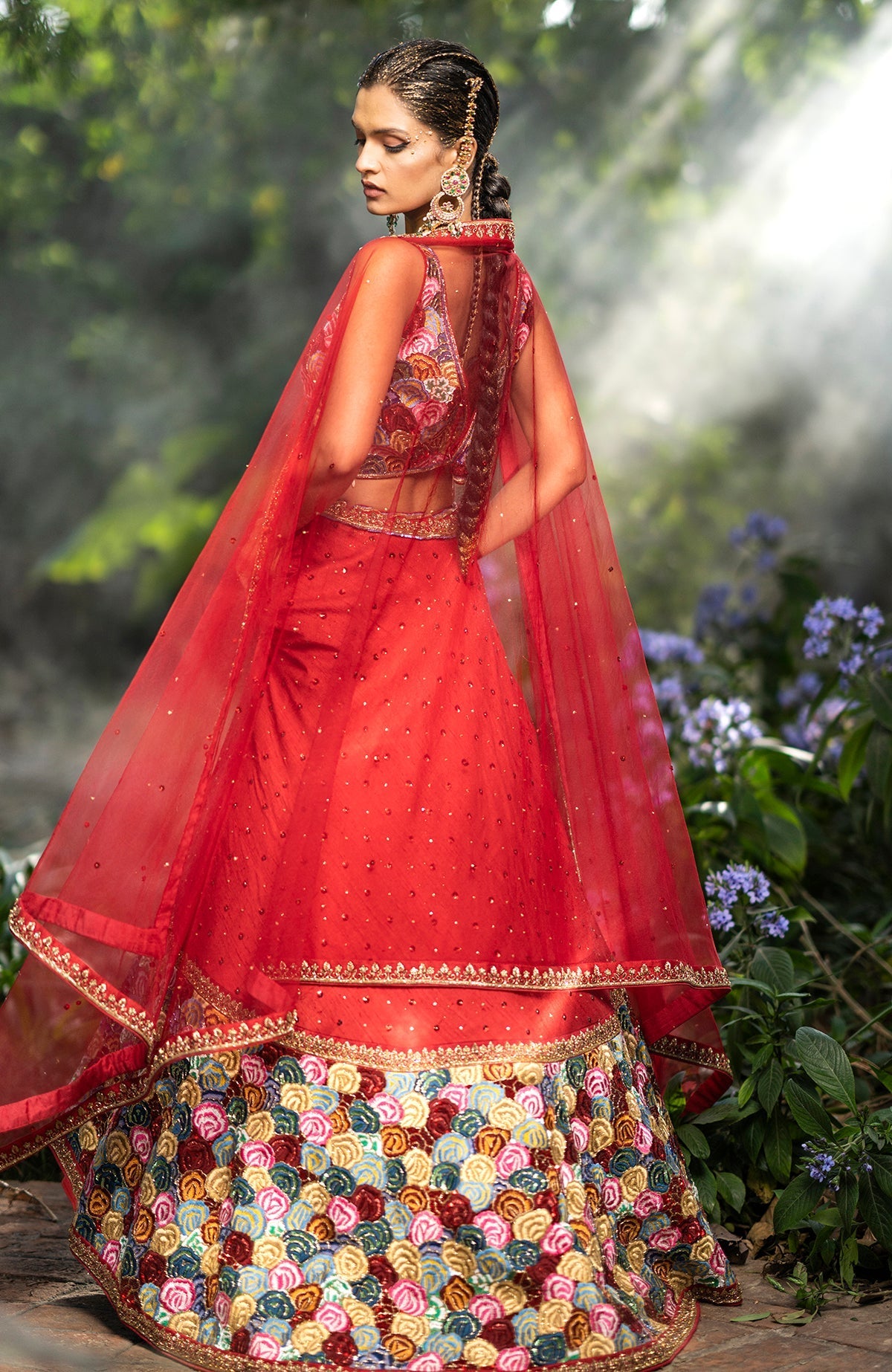 Red raw silk lehenga with multicolor floral embroidery, bead and sequin details, and sweetheart blouse.