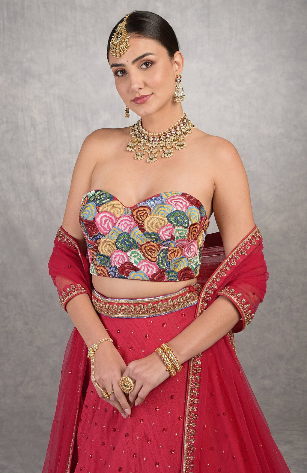 Red corset blouse with multicolor resham embroidery and floral motifs on raw silk fabric
