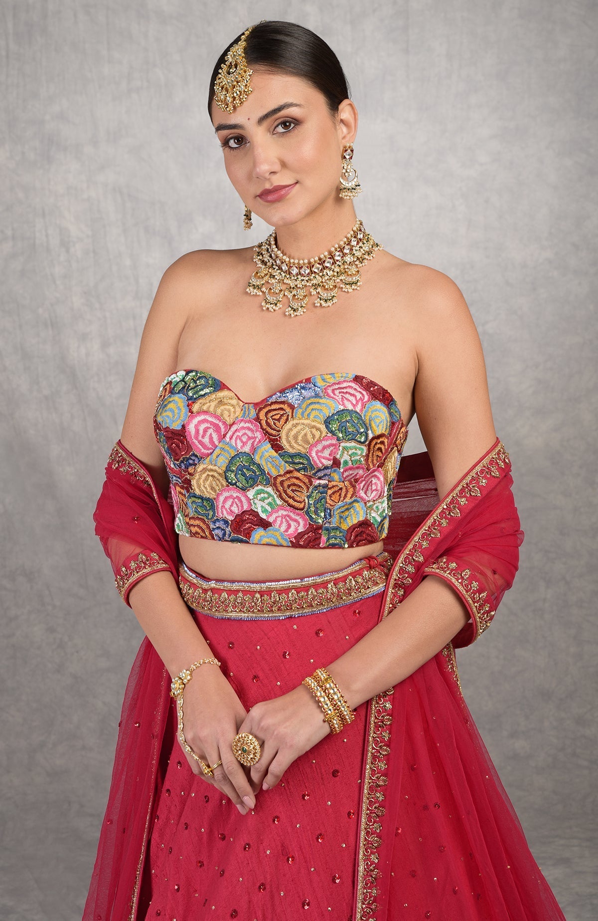Red corset blouse with multicolor resham embroidery and floral motifs on raw silk fabric