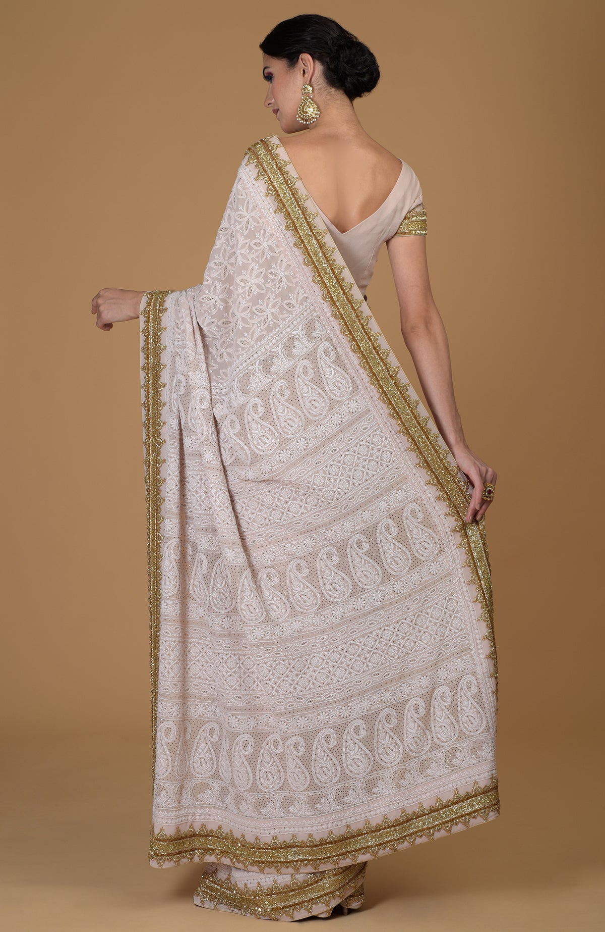 Nude pink Georgette saree with hand-embroidered Chikankari and gold Zardozi details