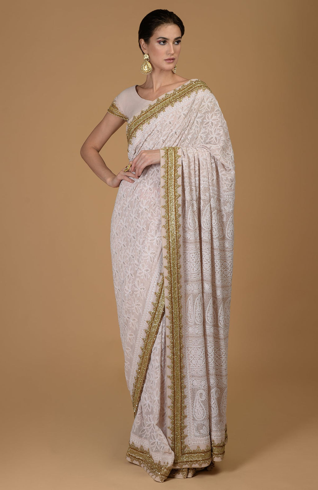 Nude pink Georgette saree with hand-embroidered Lucknowi Chikankari and gold Zardozi details