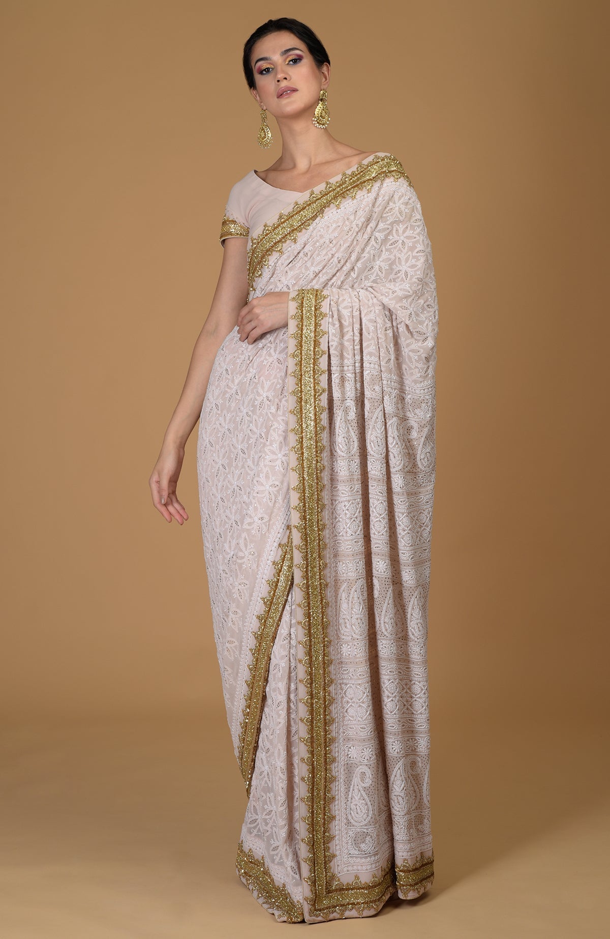 Nude pink Georgette saree with hand-embroidered Chikankari and gold Zardozi detailing