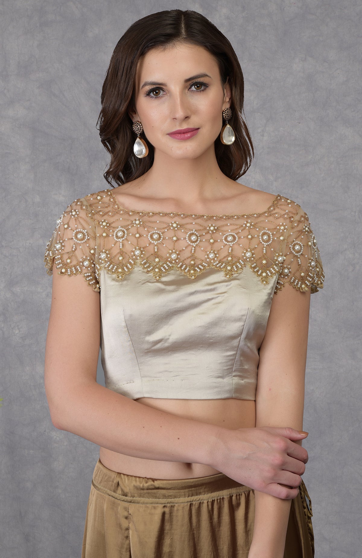 Beige French Chantilly lace saree with embroidered pearl bead floral blouse and satin fabric.