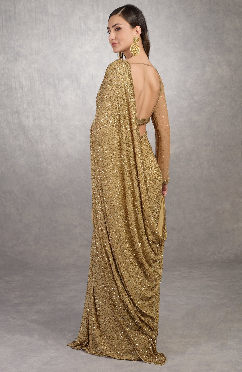 Gold Cleopatra saree with hand embroidered sequins and beads, paired with bronze scoop neck blouse.
