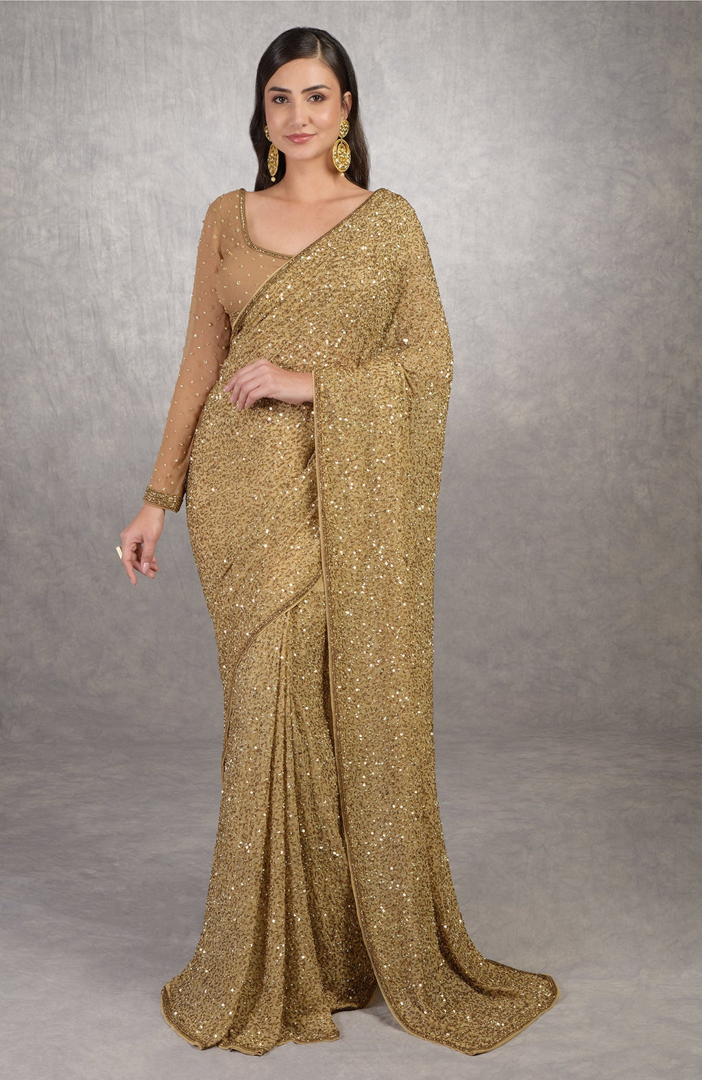 Gold Cleopatra saree with hand embroidered sequins and beads paired with bronze blouse.