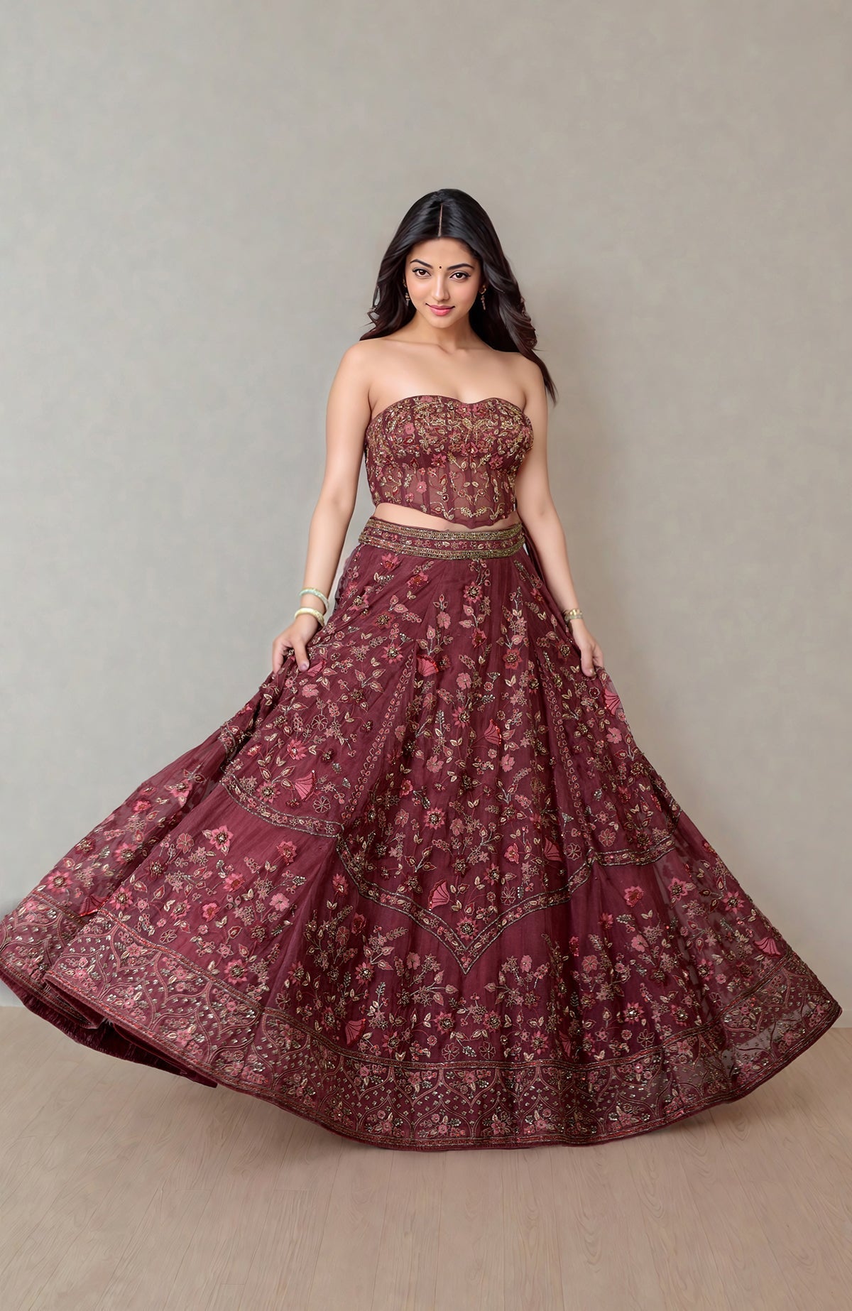Burgundy wine lehenga with floral embroidery and fitted corset featuring crystal embellishments.