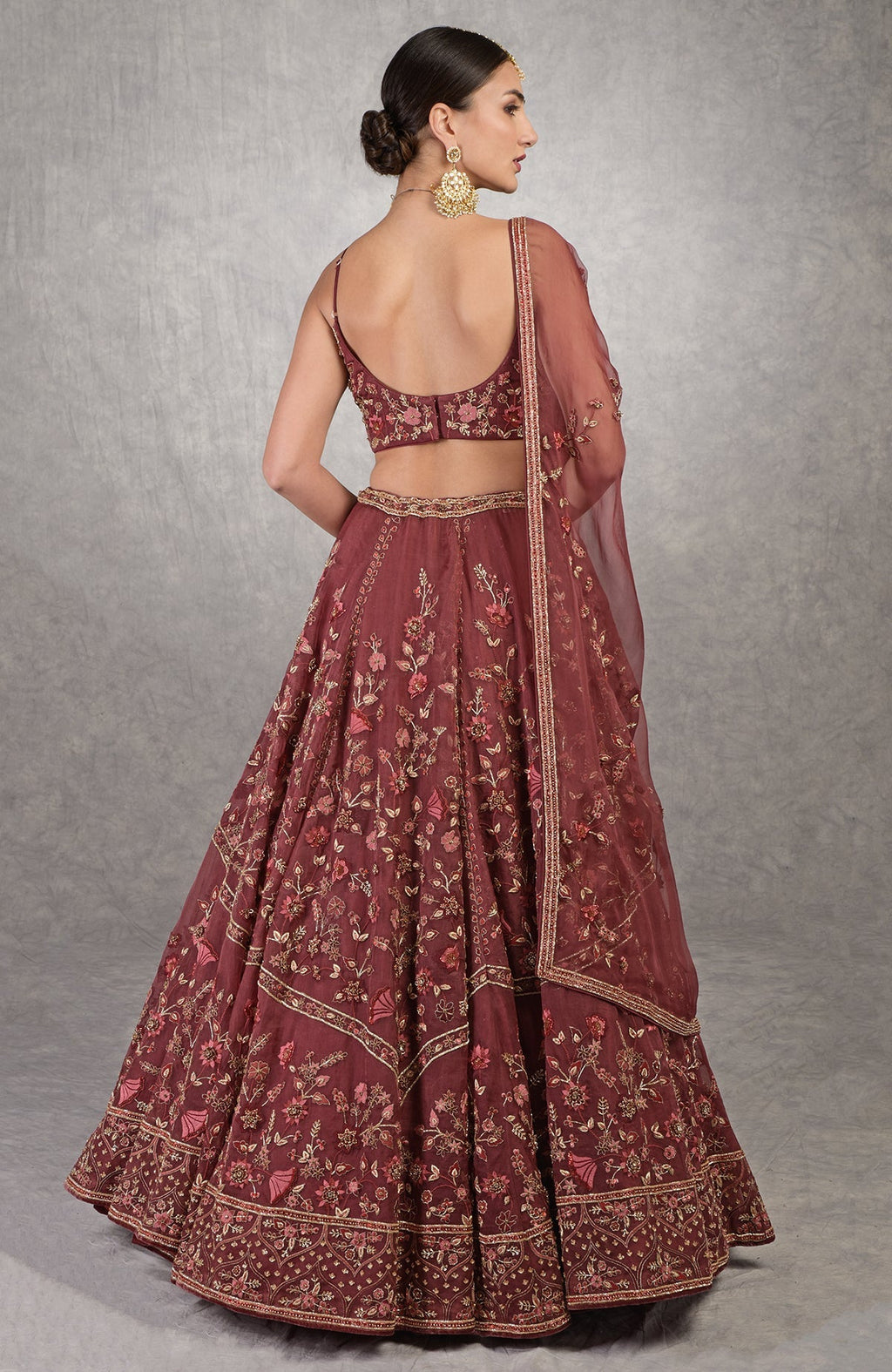Burgundy wine lehenga set with floral embroidery, crystal accents, and noodle strap blouse.