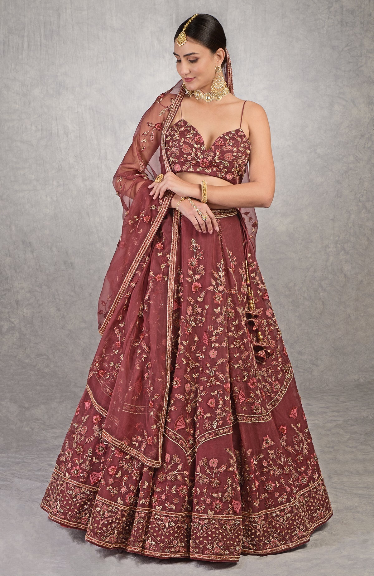 Burgundy wine lehenga set with floral embroidery, crystal accents, and noodle strap blouse.