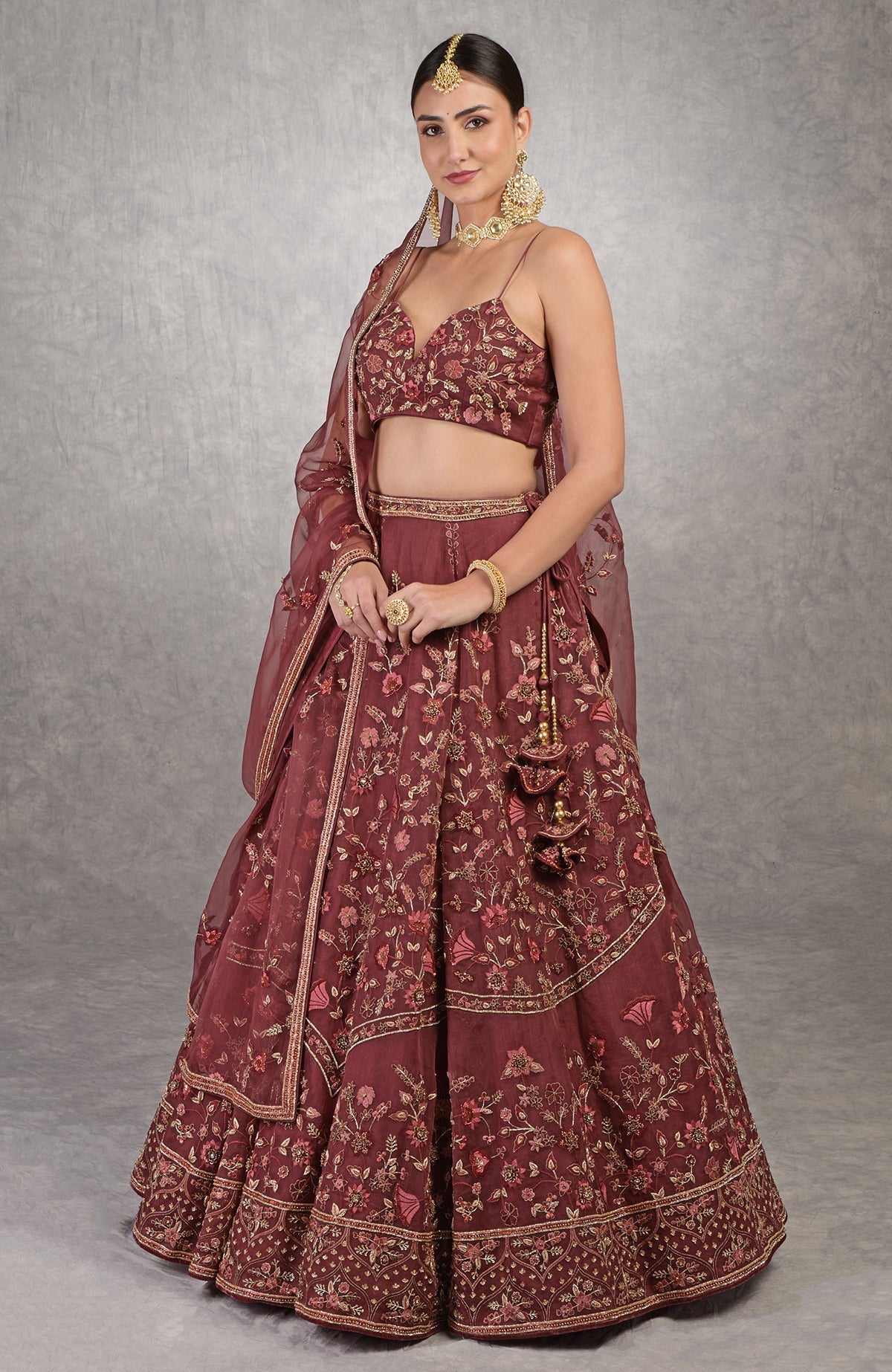 Burgundy wine lehenga set with floral embroidery, crystal accents, and noodle strap blouse.